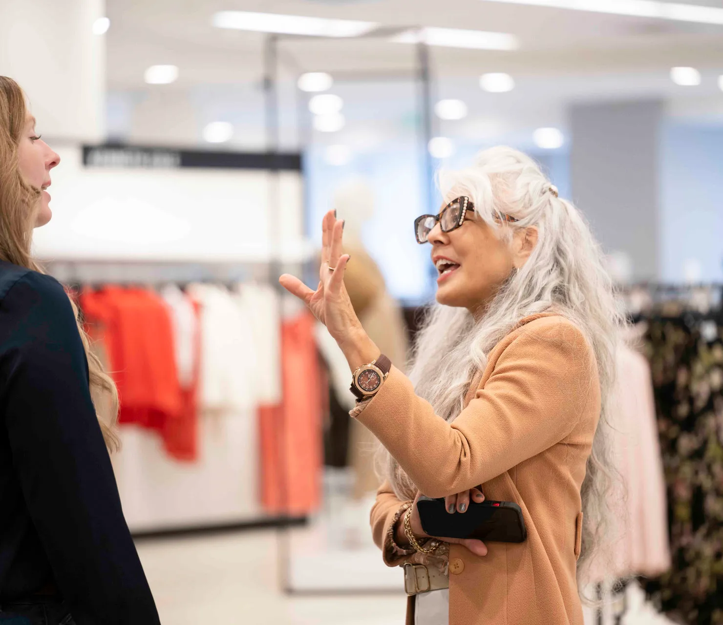 Photo of Michelle Moquin shopping and talking to another person.